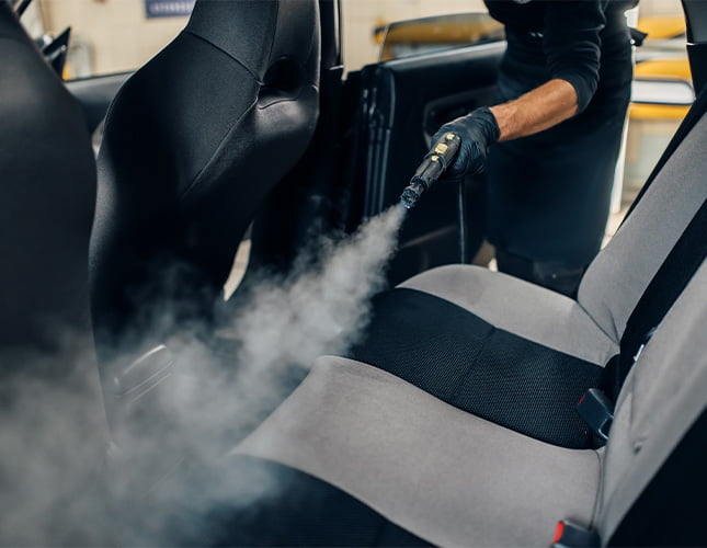 cleaning interior of car with a steam cleaner