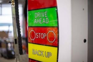 drive ahead, stop, back-up sign inside car wash