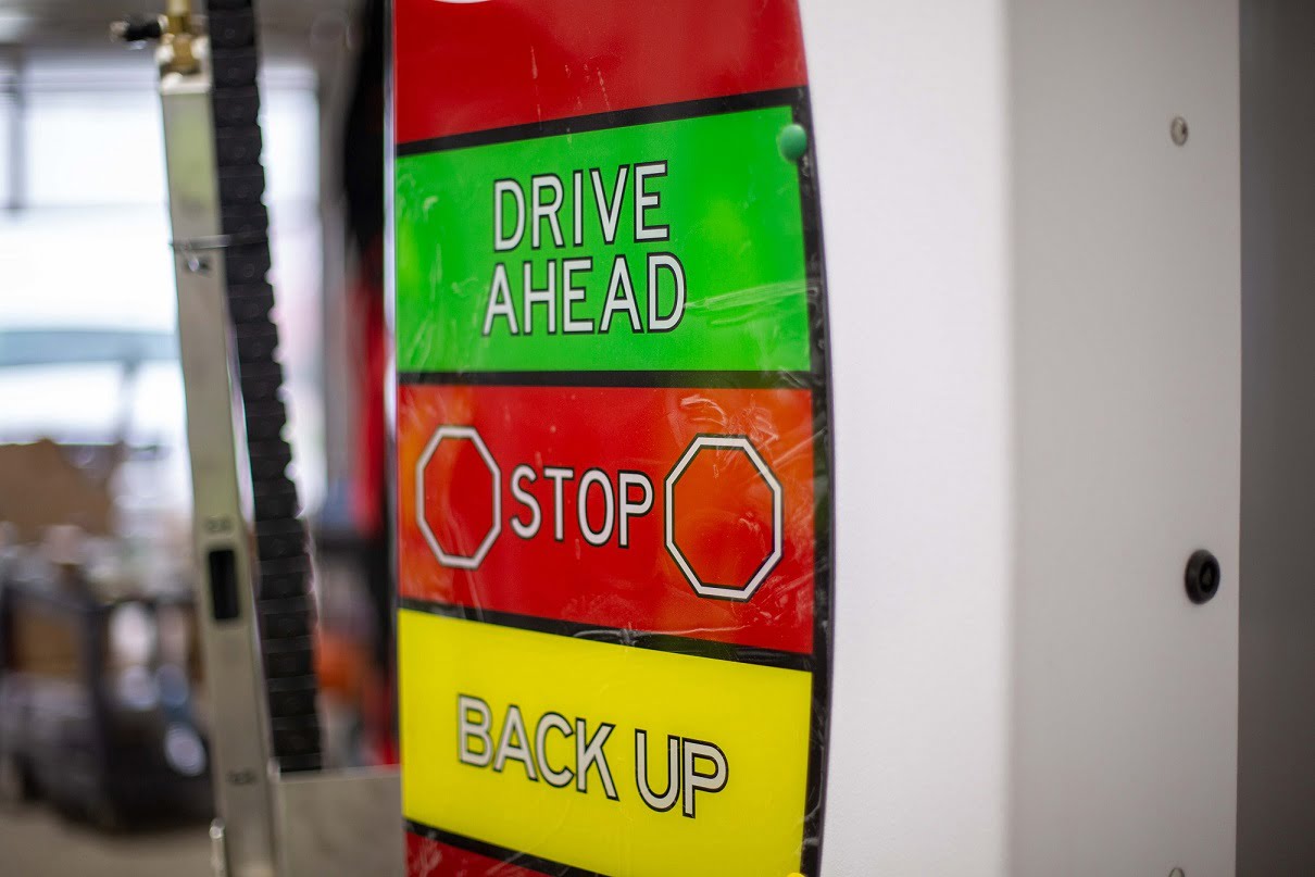 drive ahead, stop, back-up sign inside car wash