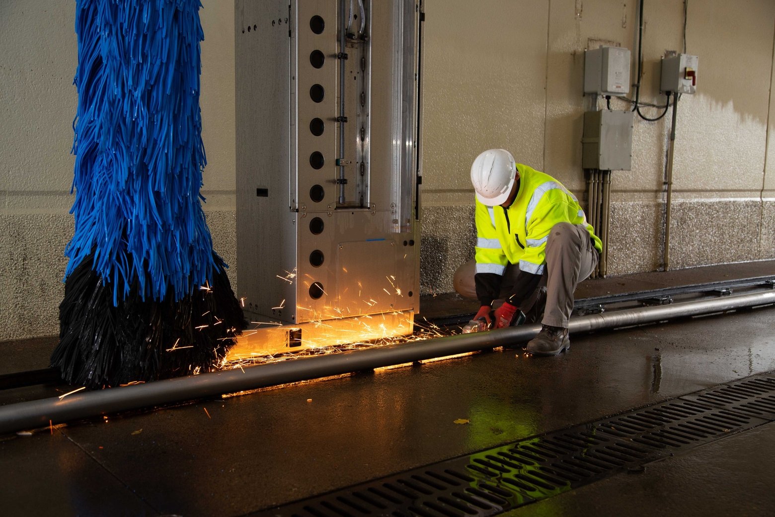 Technician working on car wash rails