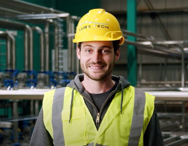 Technician wearing Lube-Tech helmet and safety vest