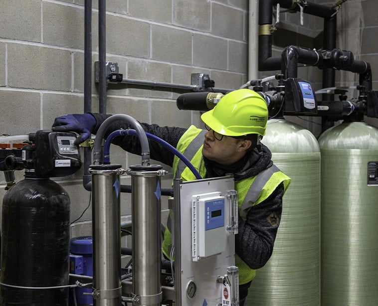 technician examining car wash equipment