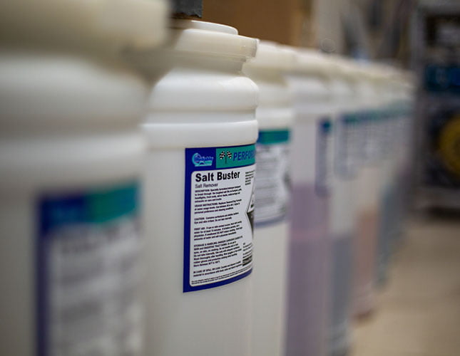Containers of car wash chemicals