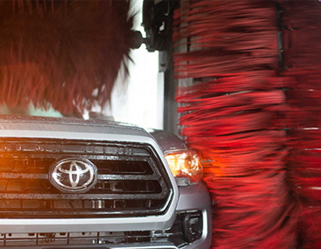 close up of pickup truck inside a soft-touch car wash