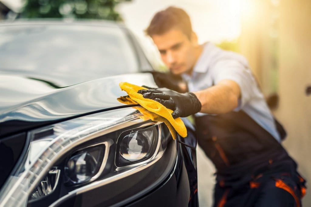 man detailing car